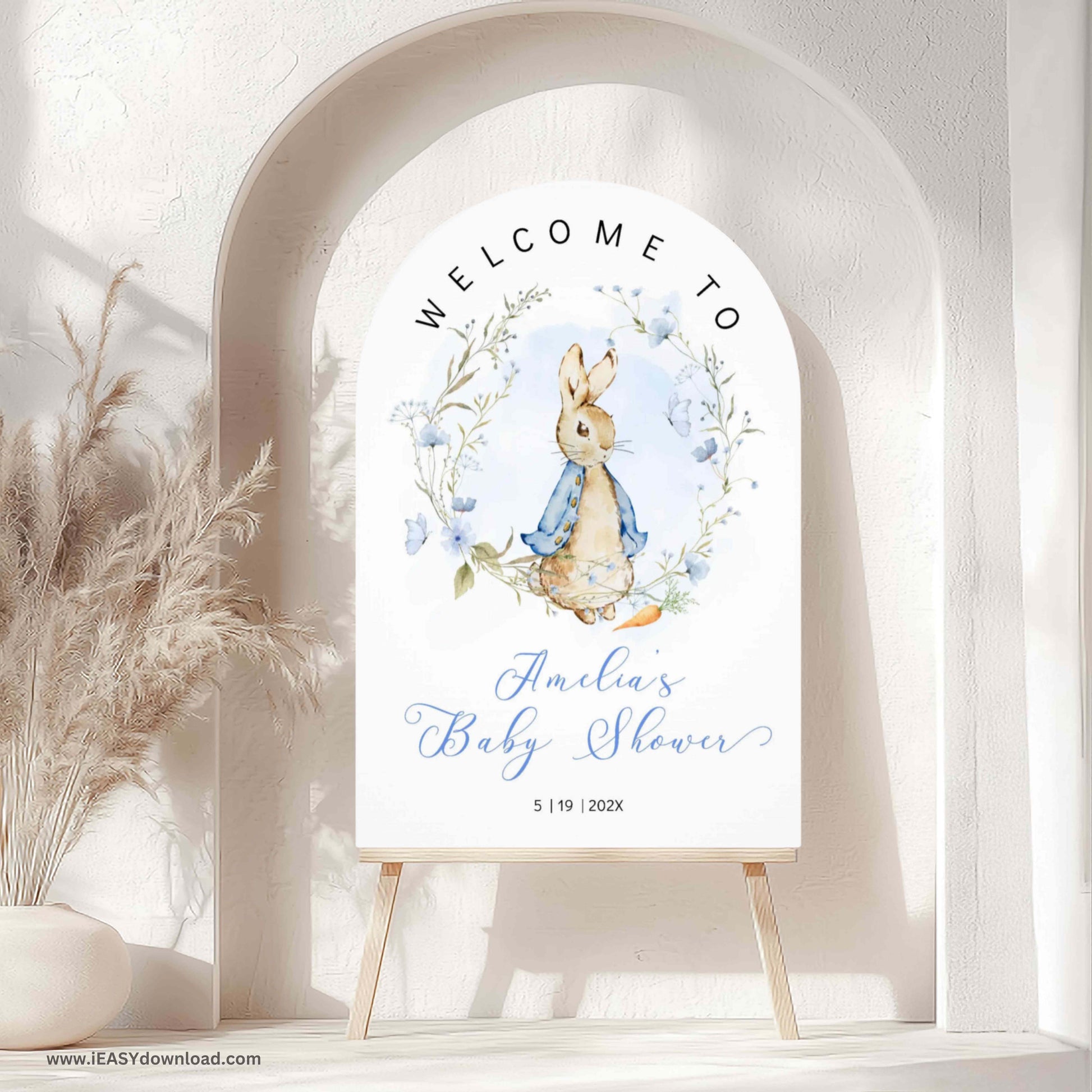 Baby shower welcome sign with Peter Rabbit design, surrounded by blue and white balloons and flowers. Printed and Free Shipping. Arch Foam Board.