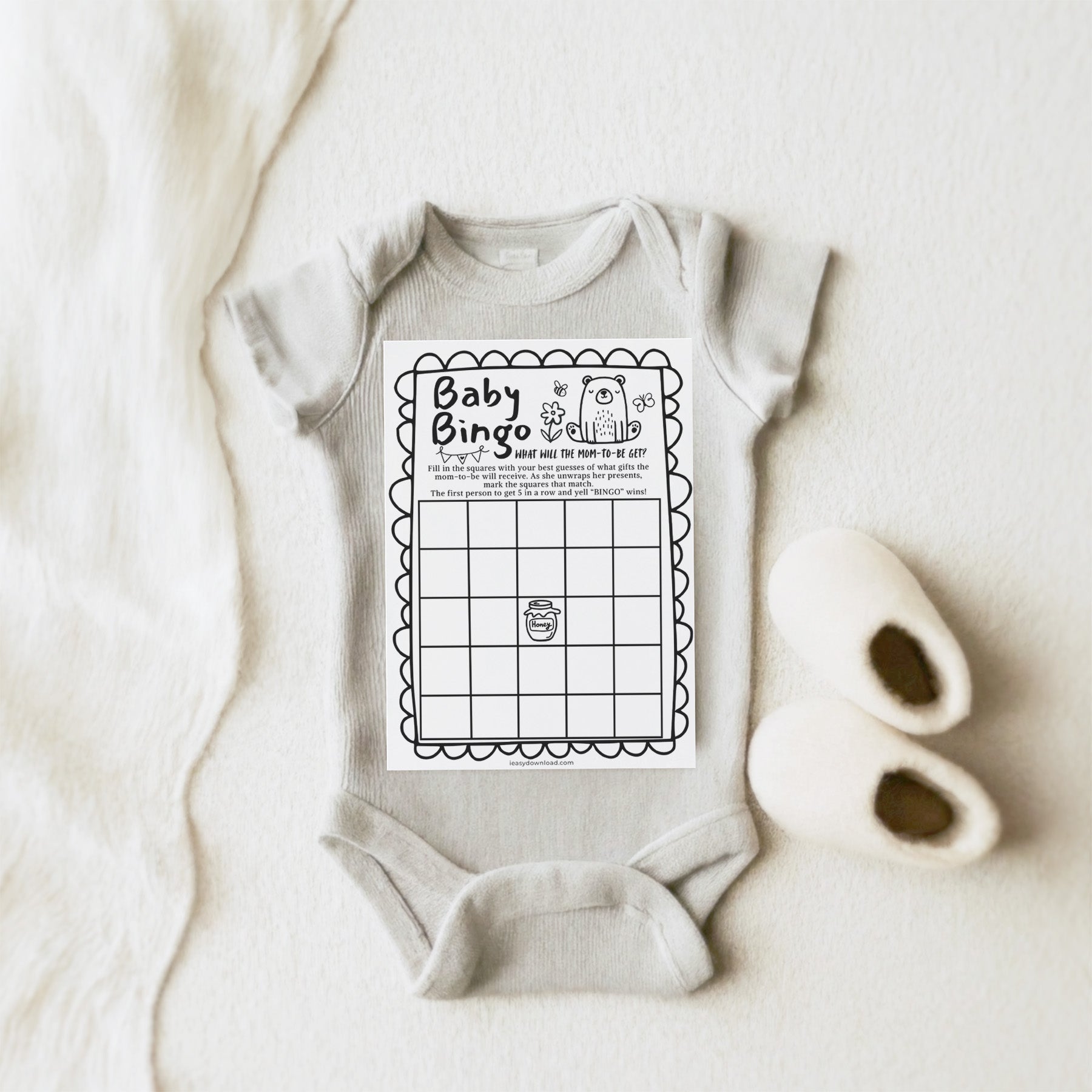 Baby onesie with a Baby Bingo game on a white background