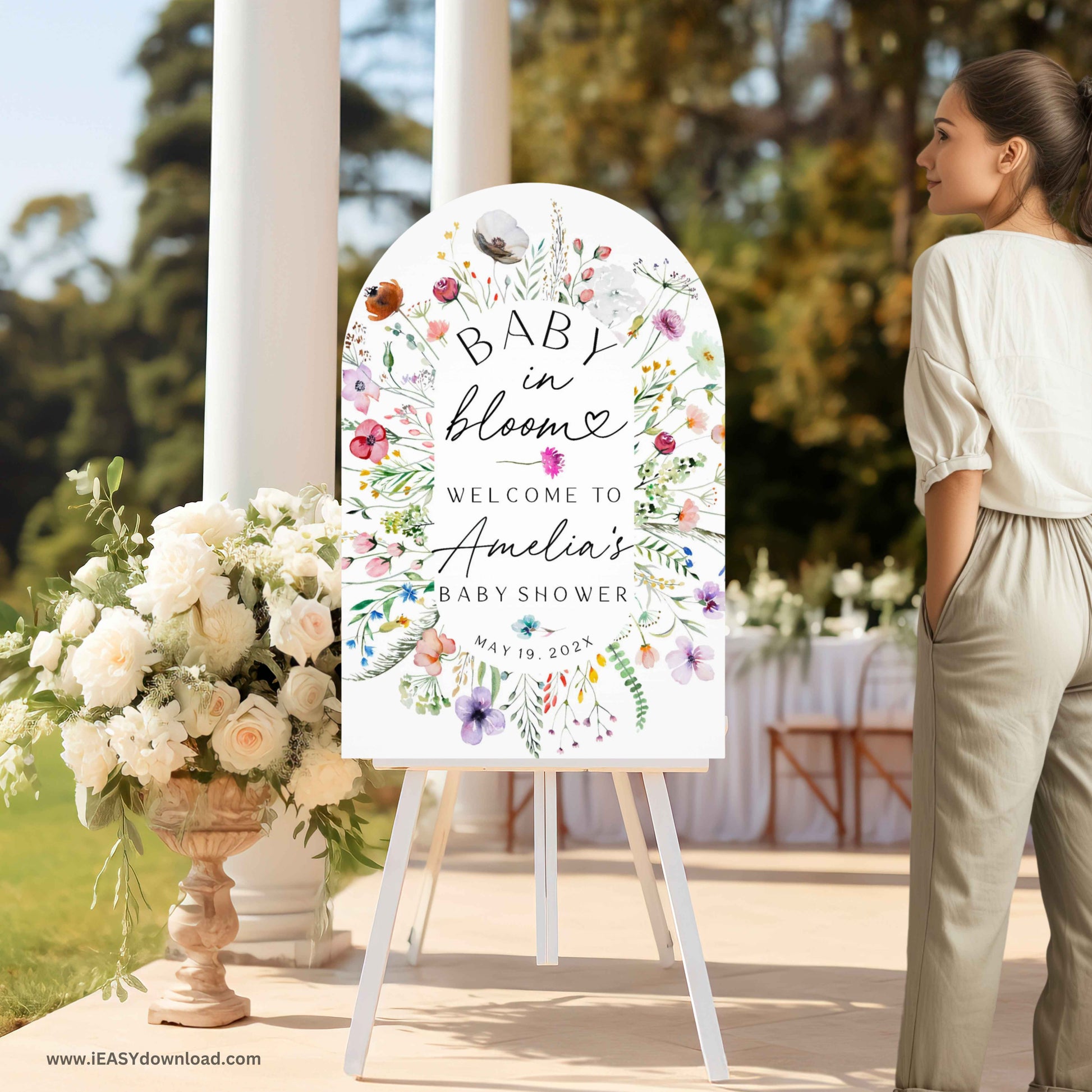 Baby shower foam arch sign with floral design and text on an easel surrounded by flowers. Printed and free shipping