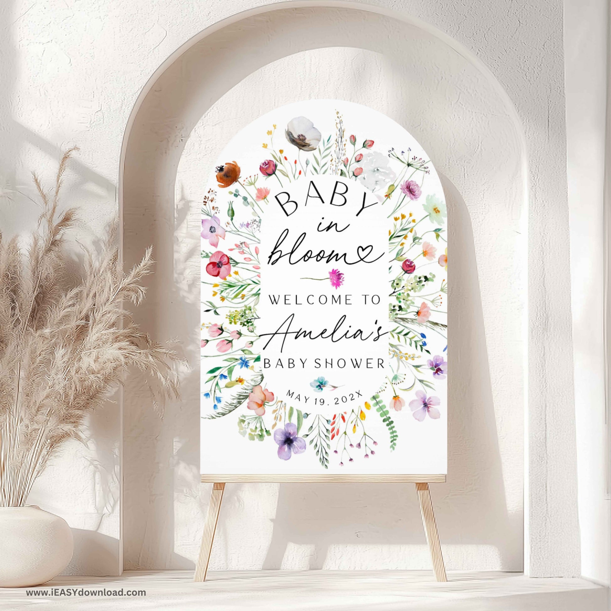Baby shower foam arch sign with floral design and text on an easel surrounded by flowers. Printed and free shipping