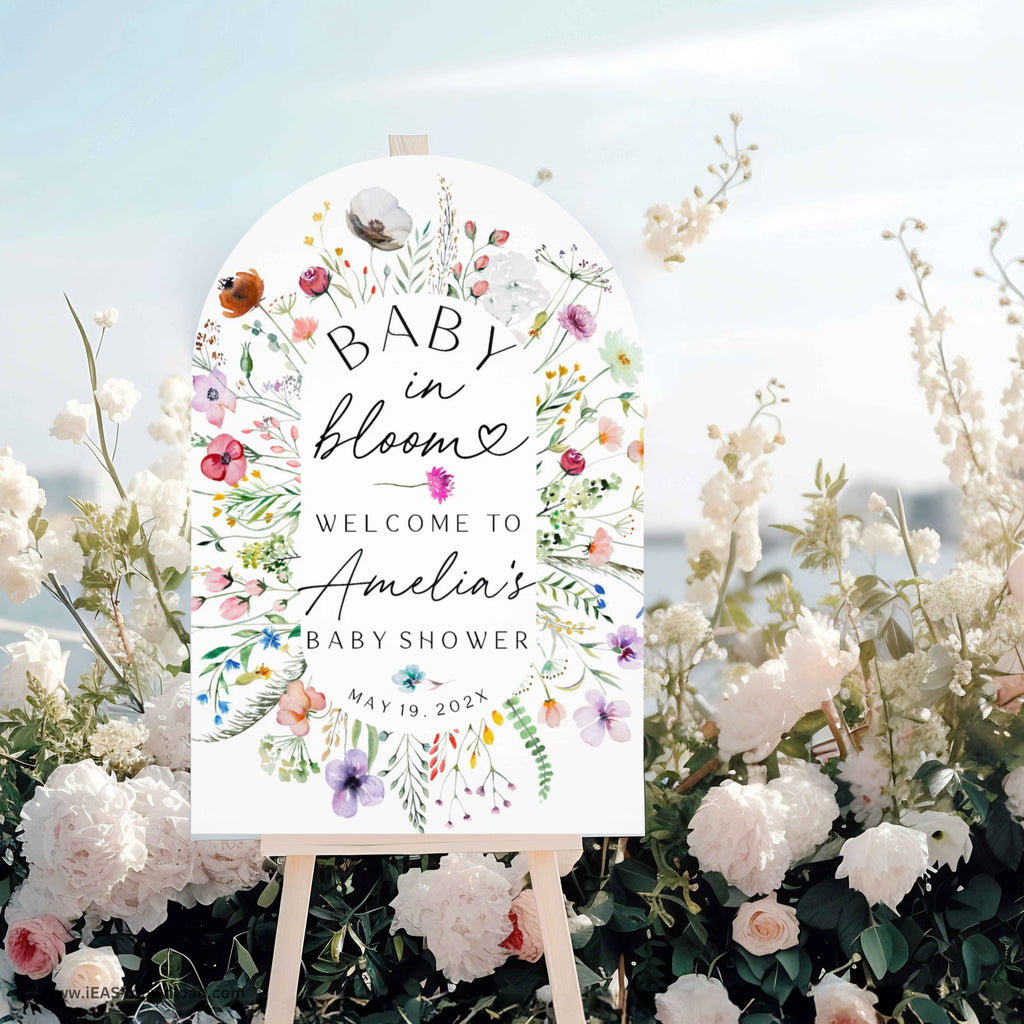 Baby shower foam arch sign with floral design and text on an easel surrounded by flowers. Printed and free shipping
