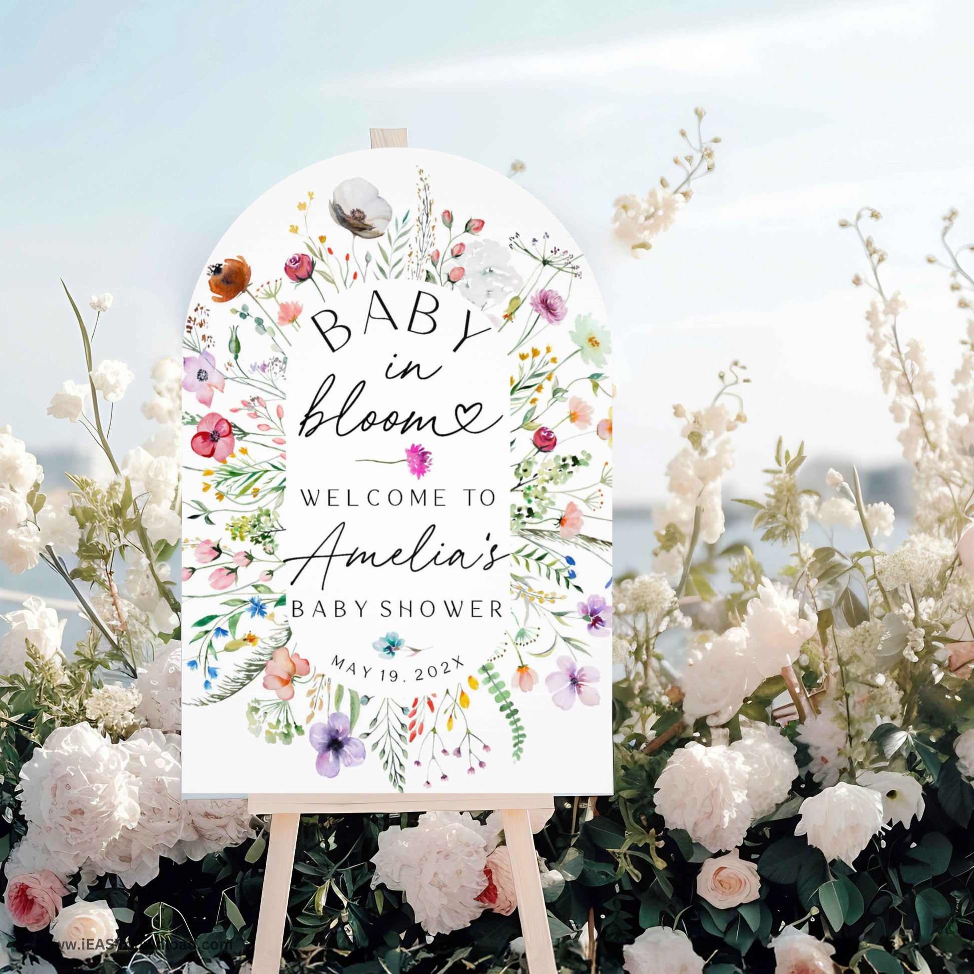 Baby shower foam arch sign with floral design and text on an easel surrounded by flowers. Printed and free shipping