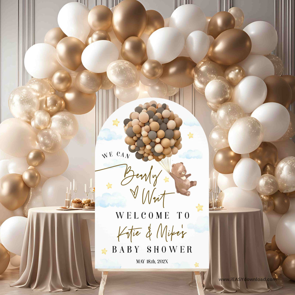 Baby shower setup with balloon arch and personalized sign