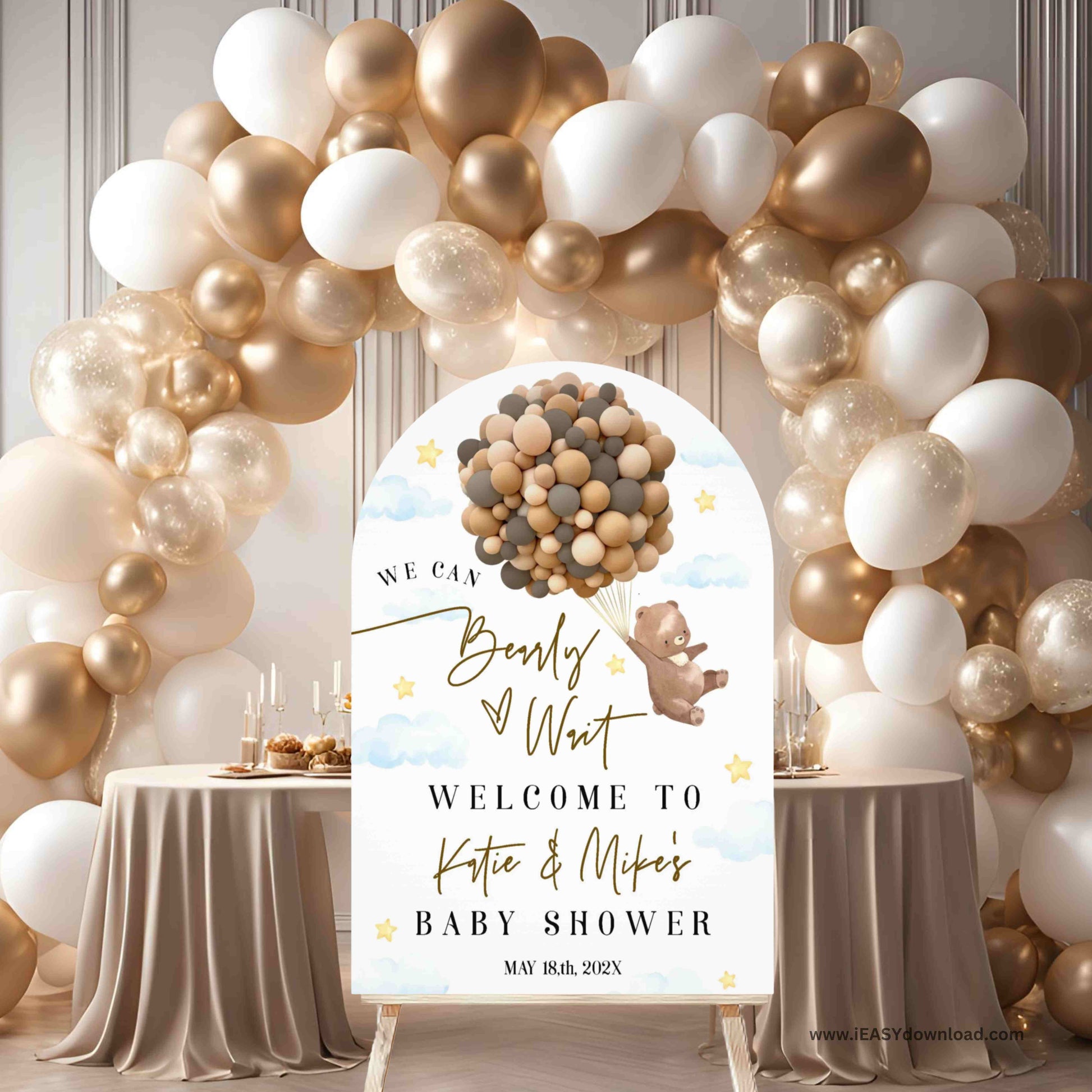 Baby shower setup with balloon arch and personalized sign
