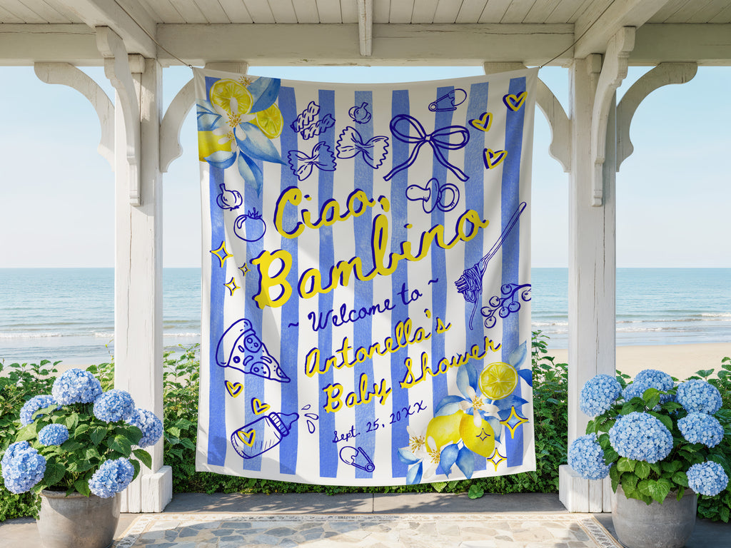 Decorative baby shower banner with blue and yellow design, text 'Ciao Bambino Welcome to Antonella's Baby Shower' on a striped background, displayed outdoors.