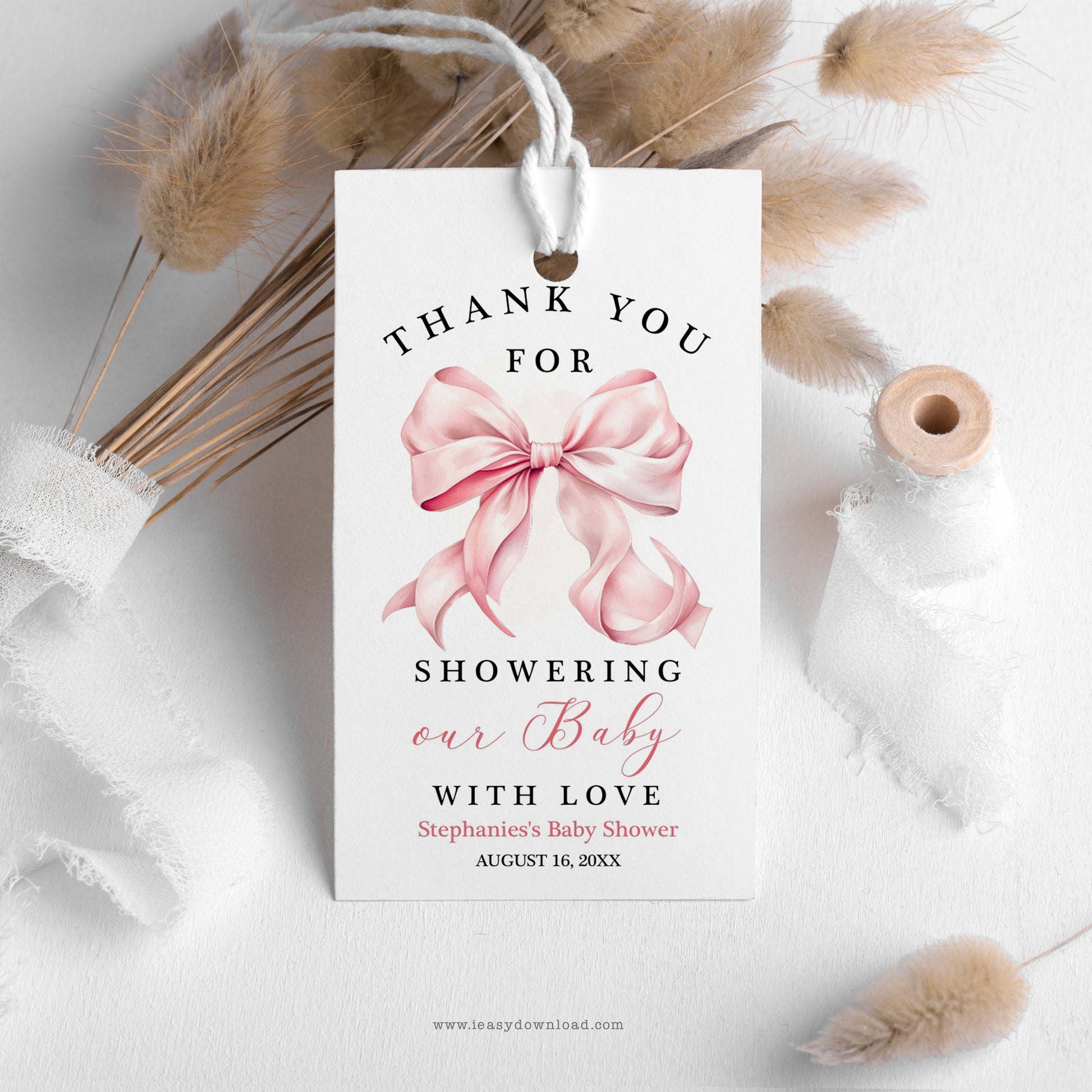 Baby shower thank you tag with pink bow design on a white background